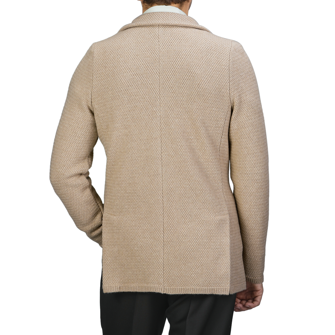 A person is shown from the back against a neutral background, wearing the Beige Merino Wool Knitted Blazer by Stenströms paired with black pants.