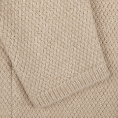 Close-up of the Beige Merino Wool Knitted Blazer by Stenströms, featuring a textured, woven pattern and highlighting a folded section in the upper left corner.