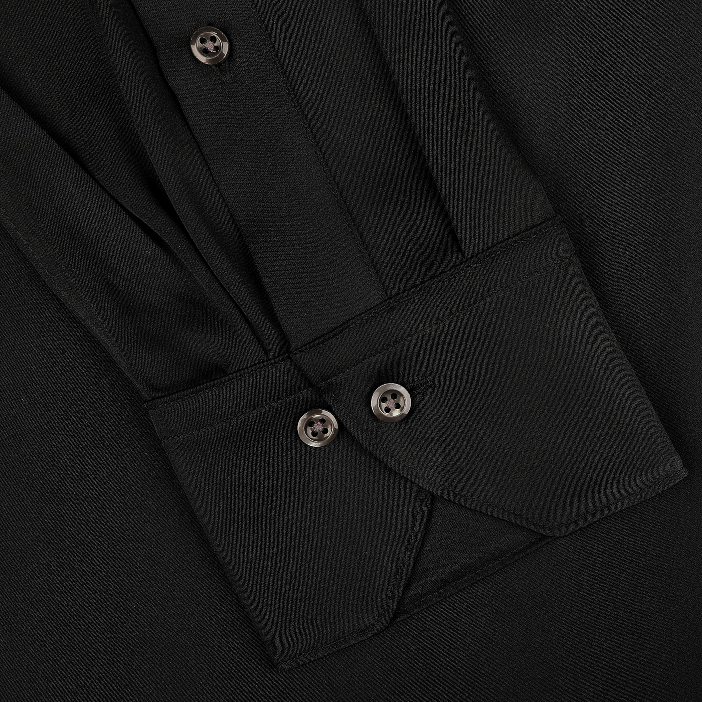 A close-up of the Stenströms Black Silk Fitted Body Shirt sleeve shows two buttons on the cuff and pleated fabric.