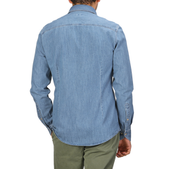 A man is seen from the back wearing a Blue Washed Cotton Denim Slimline Shirt by Stenströms, paired with green pants.