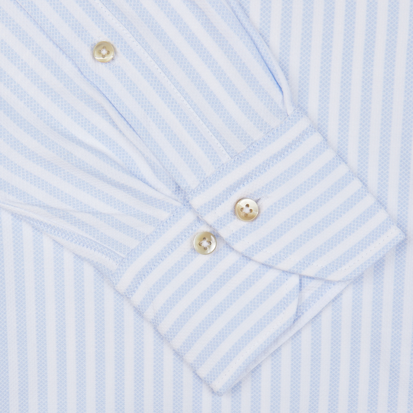 Close-up of a blue and white striped Stenströms Slimline shirt cuff with two buttons.