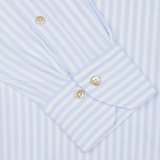 Close-up of a blue and white striped Stenströms Slimline shirt cuff with two buttons.