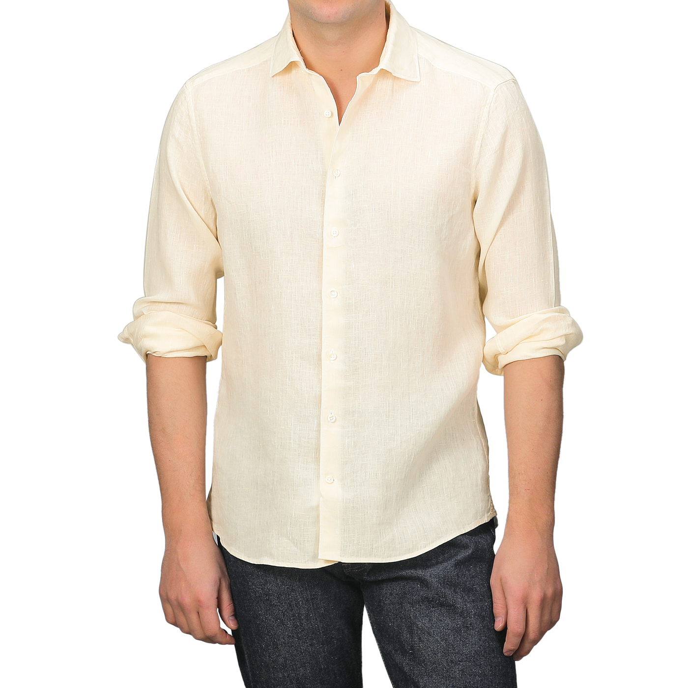 A person wears a Stenströms Butter Cream Linen Cutaway Fitted Body Shirt, ideal for summer, with rolled-up sleeves, paired with dark jeans.