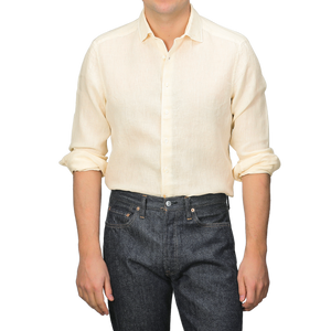 A person wearing a Stenströms Butter Cream Linen Cutaway Slimline Shirt and dark jeans stands against a neutral background.