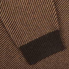 Close-up of the Camel Brown Striped Merino V-Neck Sweater by Stenströms, showcasing a striking herringbone design and finished with ribbed cuffs.