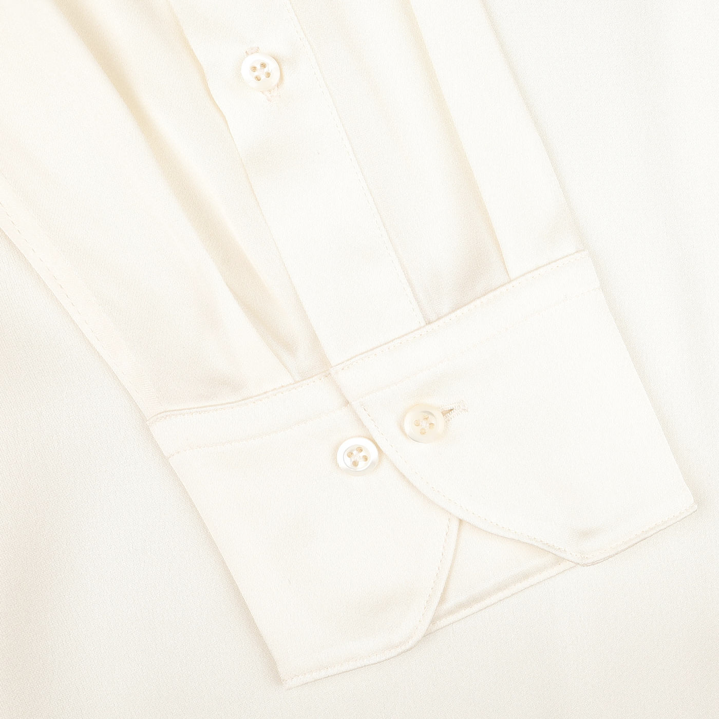 Close-up of the sleeve on our Cream Silk Fitted Body Shirt by Stenströms, highlighting its pleated fabric and buttoned cuff.