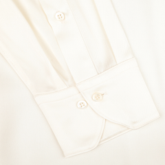 Close-up of the sleeve on our Cream Silk Fitted Body Shirt by Stenströms, highlighting its pleated fabric and buttoned cuff.