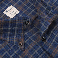 Close-up of a Dark Blue Checked Flannel Fitted Body BD Shirt with a visible "Stenströms" label, indicating it is a medium size shirt made of merino wool. The button-down collar and luxurious feel make this brushed cotton twill garment both stylish and comfortable.