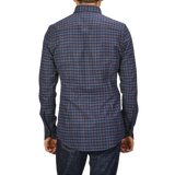 A person wearing a Dark Blue Checked Flannel Slimline BD Shirt by Stenströms and dark jeans, viewed from behind.