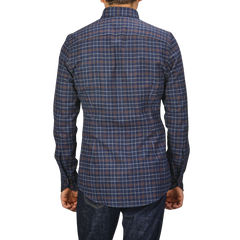 A person wearing a Dark Blue Checked Flannel Slimline BD Shirt by Stenströms and dark jeans, viewed from behind.