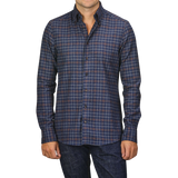 A person wearing a Dark Blue Checked Flannel Slimline BD Shirt by Stenströms, paired with dark blue jeans, stands against a plain background.