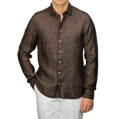 Someone is wearing a Stenströms Dark Brown Linen Cutaway Fitted Body Shirt with white buttons, paired with crisp white pants.