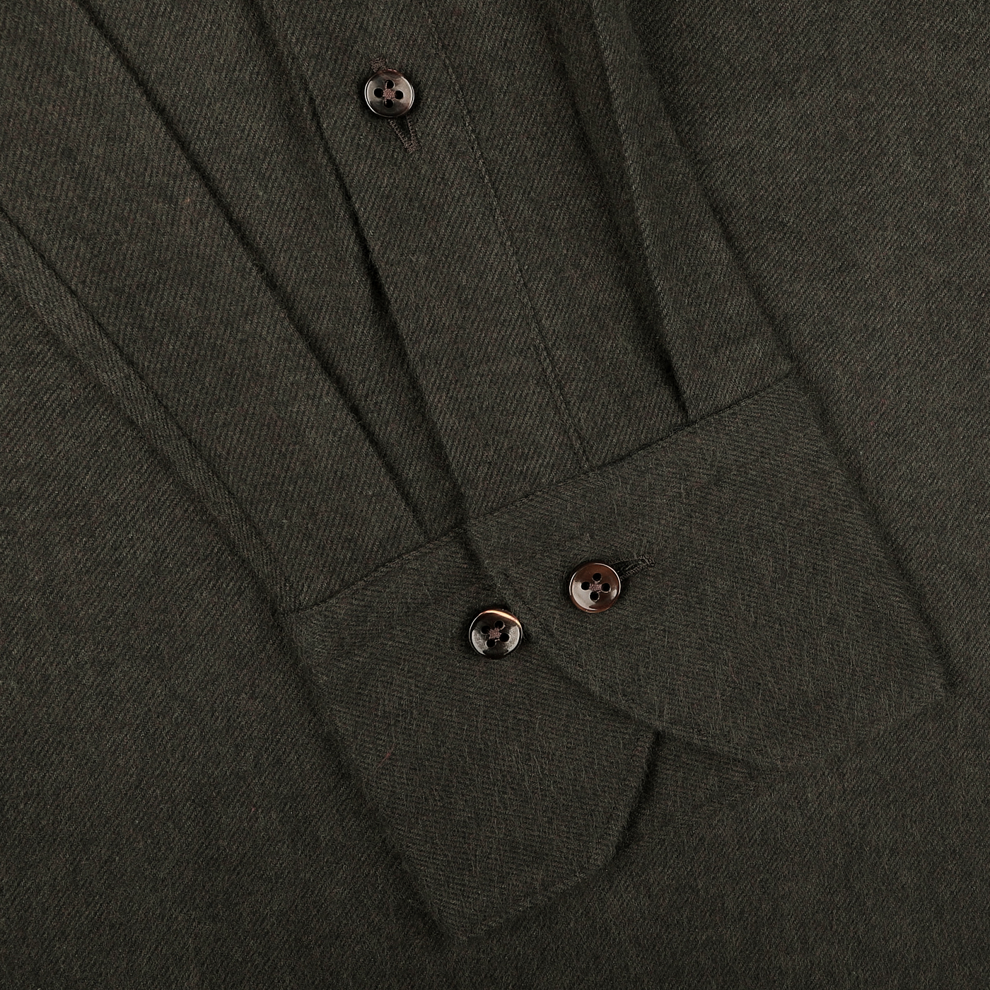 Close-up of the fabric from a Dark Green Cotton Flannel Fitted Body Shirt by Stenströms, featuring two buttons visible on the sleeve.