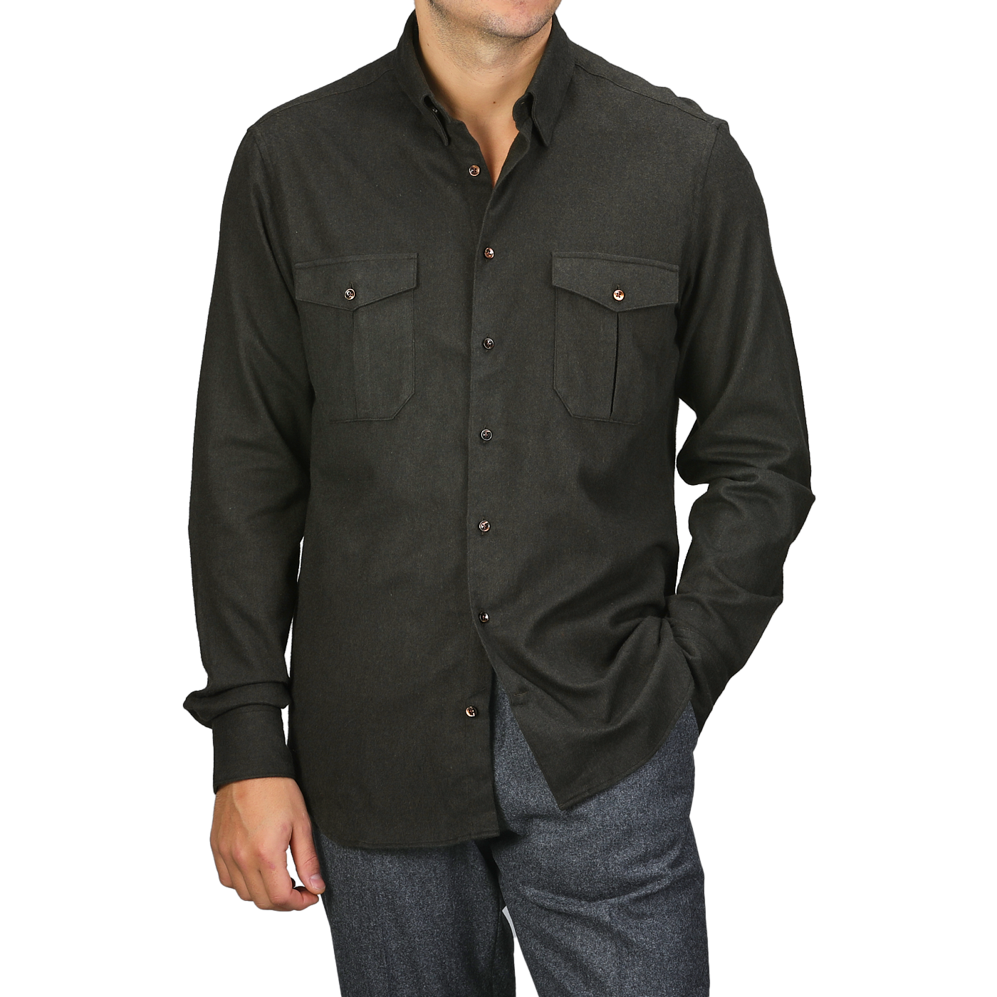 A person wearing a Dark Green Cotton Flannel Fitted Body Shirt by Stenströms from a capsule collection with two chest pockets and gray trousers, standing with one hand in a pocket.