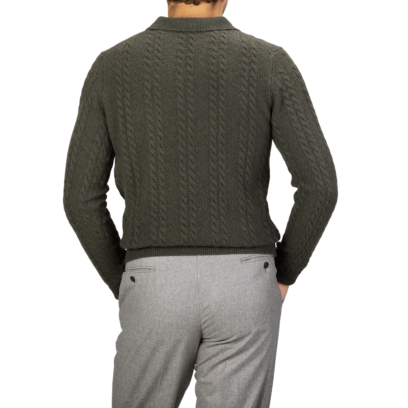 Wearing the Dark Green Merino Cable Knit LS Polo from Stenströms, paired with gray pants and captured from behind, a person exudes the effortless elegance of a capsule collection.