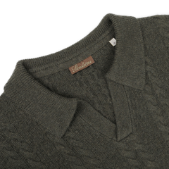 Close-up of the Dark Green Merino Cable Knit LS Polo with a folded collar, crafted by Stenströms.