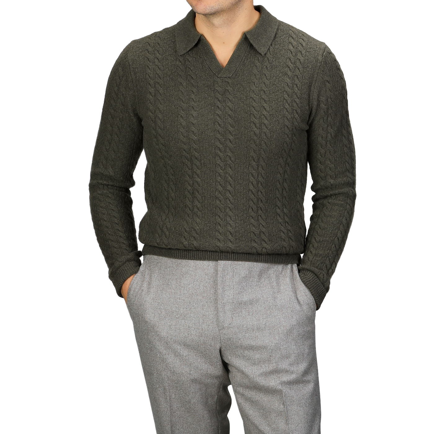 A person wearing a Dark Green Merino Cable Knit LS Polo by Stenströms from the capsule collection and gray pants, with hands in pockets.