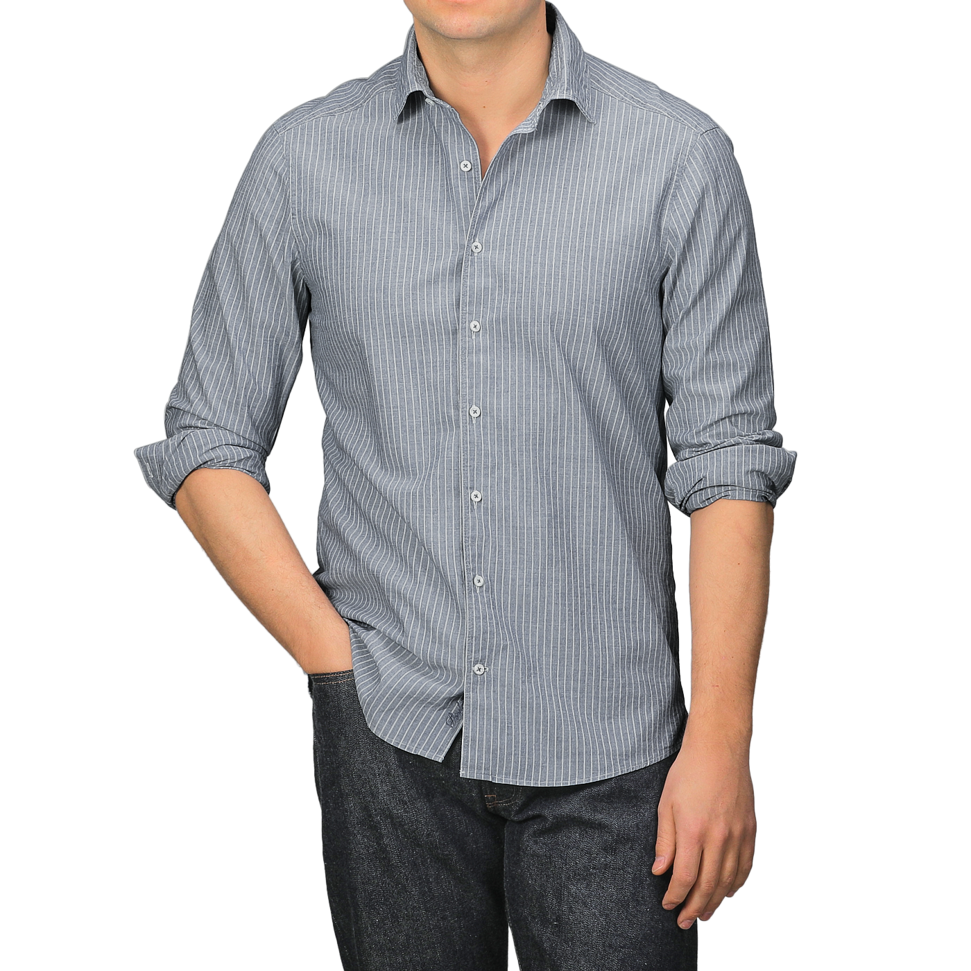 A person wearing a Stenströms Dark Indigo Striped Washed Cotton Fitted Body Shirt and dark jeans stands with one hand in a pocket.