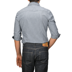 A person is seen from the back wearing a Stenströms Dark Indigo Striped Washed Cotton Slimline Shirt with dark jeans.