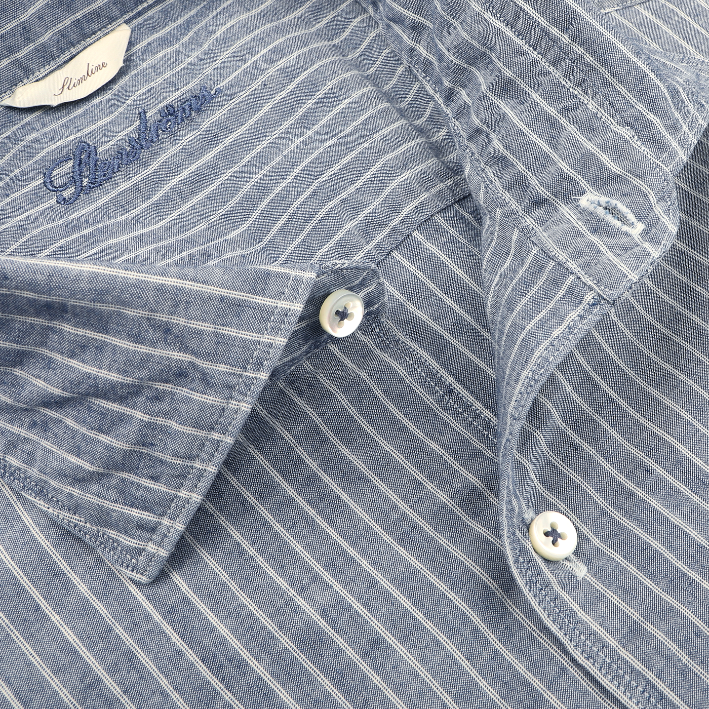 Close-up of the Stenströms Dark Indigo Striped Washed Cotton Slimline Shirt, showcasing a cut-away collar and its two visible buttons.