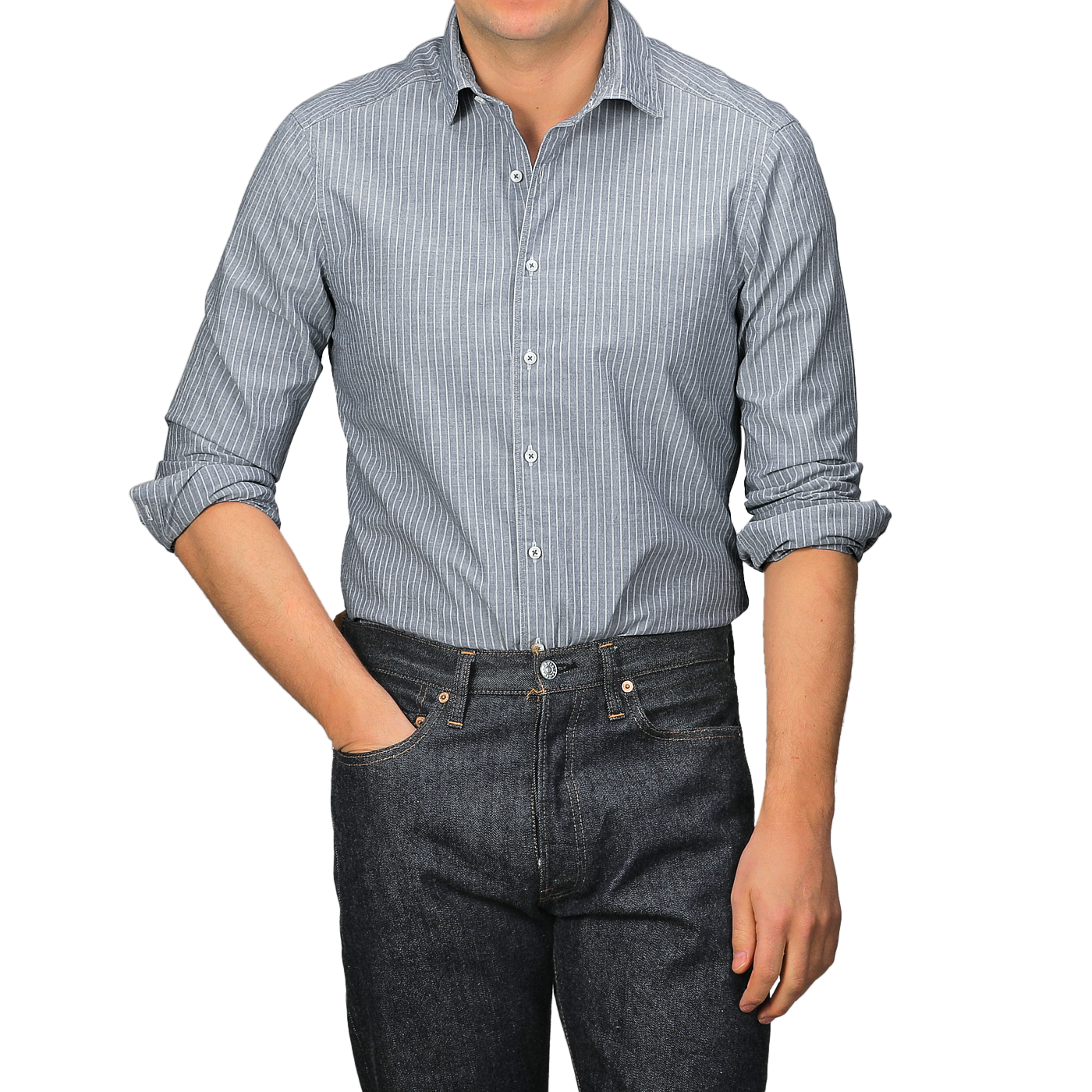 A person wearing a Stenströms Dark Indigo Striped Washed Cotton Slimline Shirt with a cut-away collar and dark jeans stands with one hand in a pocket.