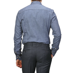 A person is shown from the back wearing a Stenströms Denim Blue Cotton Flannel Cut-Away Slimline Shirt and dark gray trousers.