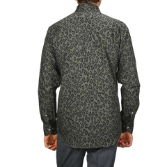 Rear view of a person wearing Stenströms' Green Animal Printed Fitted Body Shirt paired with gray pants against a plain background.