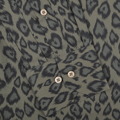 A close-up of the Green Animal Printed Fitted Body Shirt by Stenströms, showcasing a black leopard print design and beige buttons on the cuff from their 125th birthday collection.