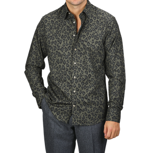 A person wearing a Green Animal Printed Fitted Body Shirt and gray pants stands against a plain background, showcasing a stylish selection from Stenströms.