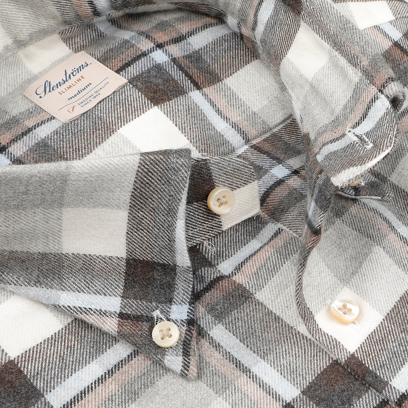 Close-up of the Stenströms Grey Checked Cotton Flannel Slimline BD Shirt, crafted from brushed cotton twill, featuring buttons and a label on the collar.