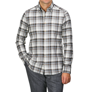 A person wearing the Grey Checked Cotton Flannel Slimline BD Shirt by Stenströms, paired with gray pants, stands with one hand in their pocket against a plain background, with the brushed cotton twill enhancing the shirt’s Slimline cut.