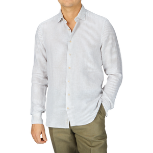 A man wearing a Light Grey Striped Linen Slimline Shirt by Stenströms and khaki pants.