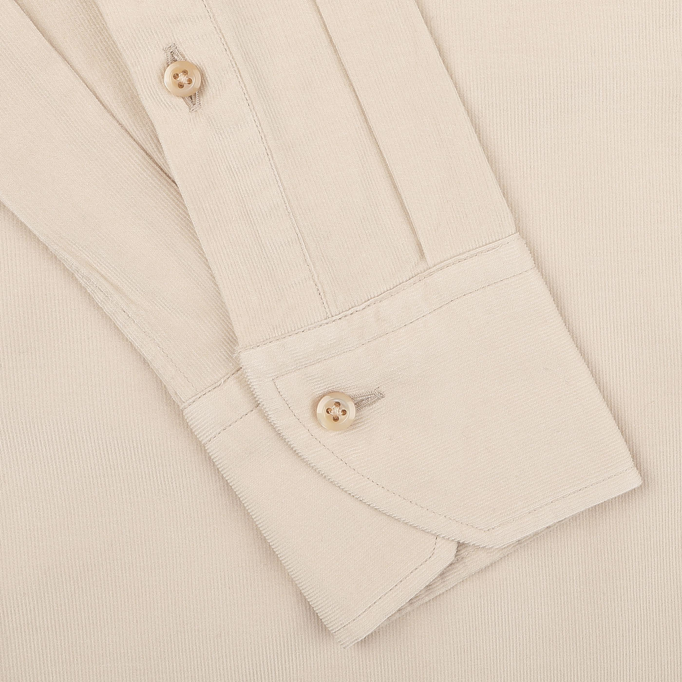 Close-up of a Stenströms Light Beige Cotton Corduroy Slimline Shirt cuff and sleeve, featuring two brown buttons and visible stitching details, showcasing the pure cotton fabric.