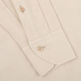 Close-up of a Stenströms Light Beige Cotton Corduroy Slimline Shirt cuff and sleeve, featuring two brown buttons and visible stitching details, showcasing the pure cotton fabric.