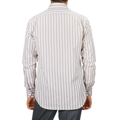 A person is seen from the back wearing the Light Beige Striped Cotton Fitted Body Shirt by Stenströms, featuring retro stripes in beige and white, paired with gray pants. The pure cotton twill fabric enhances the sleek appearance of its Fitted Body design.