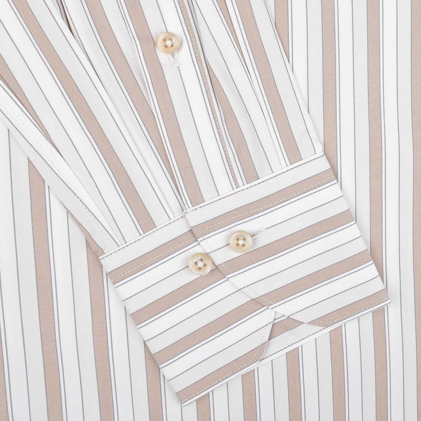 A close-up of the Light Beige Striped Cotton Fitted Body Shirt by Stenströms, highlighting its beige and white vertical stripes. This retro-inspired shirt is made from pure cotton twill and features a fitted body cut with buttoned cuffs and sleek buttons along the placket.