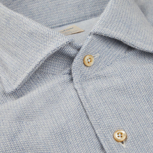A close up of a Stenströms Light Blue Brushed Cotton Fitted Body Shirt with gold buttons.