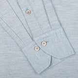 Close-up of the Light Blue Cotton Flannel Slimline BD Shirt by Stenströms, showcasing its white buttons and buttonholes on the cuffs, laid flat against a matching light blue background.