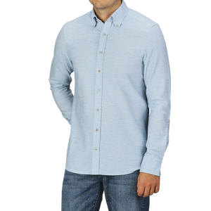 A man wearing a Stenströms Light Blue Cotton Flannel Slimline BD Shirt and blue jeans stands against a plain background. His hands are in his pockets, and his face is partially out of the frame.