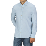 A man wearing a Stenströms Light Blue Cotton Flannel Slimline BD Shirt and blue jeans stands against a plain background. His hands are in his pockets, and his face is partially out of the frame.