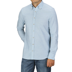 A person wearing a light blue Stenströms Light Blue Cotton Flannel Fitted Body BD Shirt and blue jeans stands against a plain gray background. The shirt has long sleeves and a collar, made from brushed cotton twill for a comfortable yet stylish look.