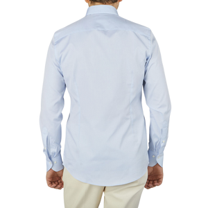 A man, wearing a Stenströms Light Blue Cotton Oxford BD Slimline Shirt, is seen from the back. He is dressed in a light blue formal shirt.
