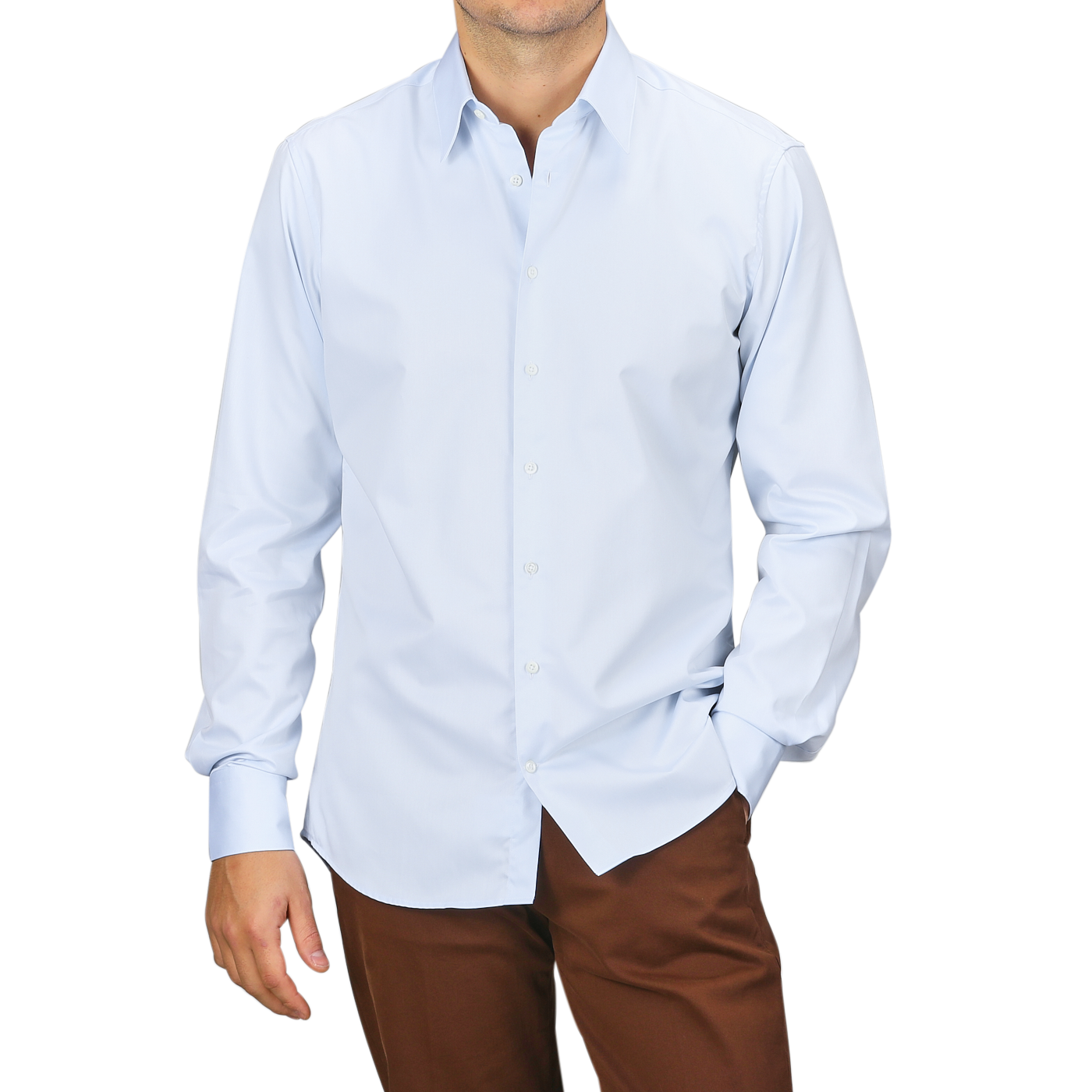 A person wearing the Stenströms Light Blue Cotton Twill Fitted Body Shirt paired with brown pants poses with one hand in the pocket against a plain background.