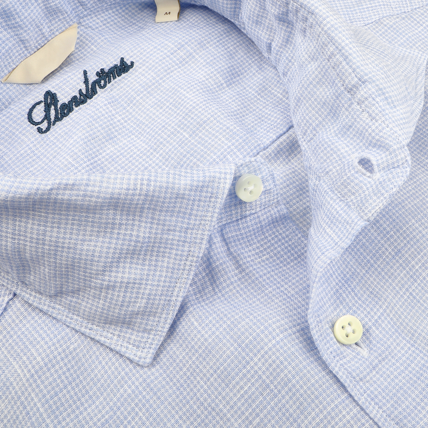 Close-up of a Light Blue Micro-Checked Linen Fitted Body Shirt with white buttons, ideal for summer. Inside label reads "Stenströms," highlighting its impeccable fit.