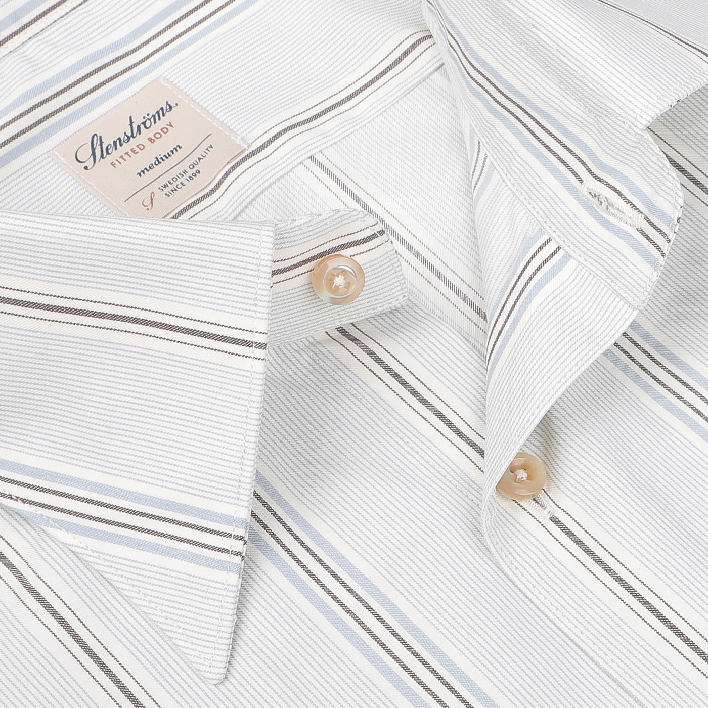 Close-up of the Stenströms Light Blue Striped Cotton Fitted Body Shirt, featuring a retro-striped design in cotton twill and a partially open top button revealing its label.