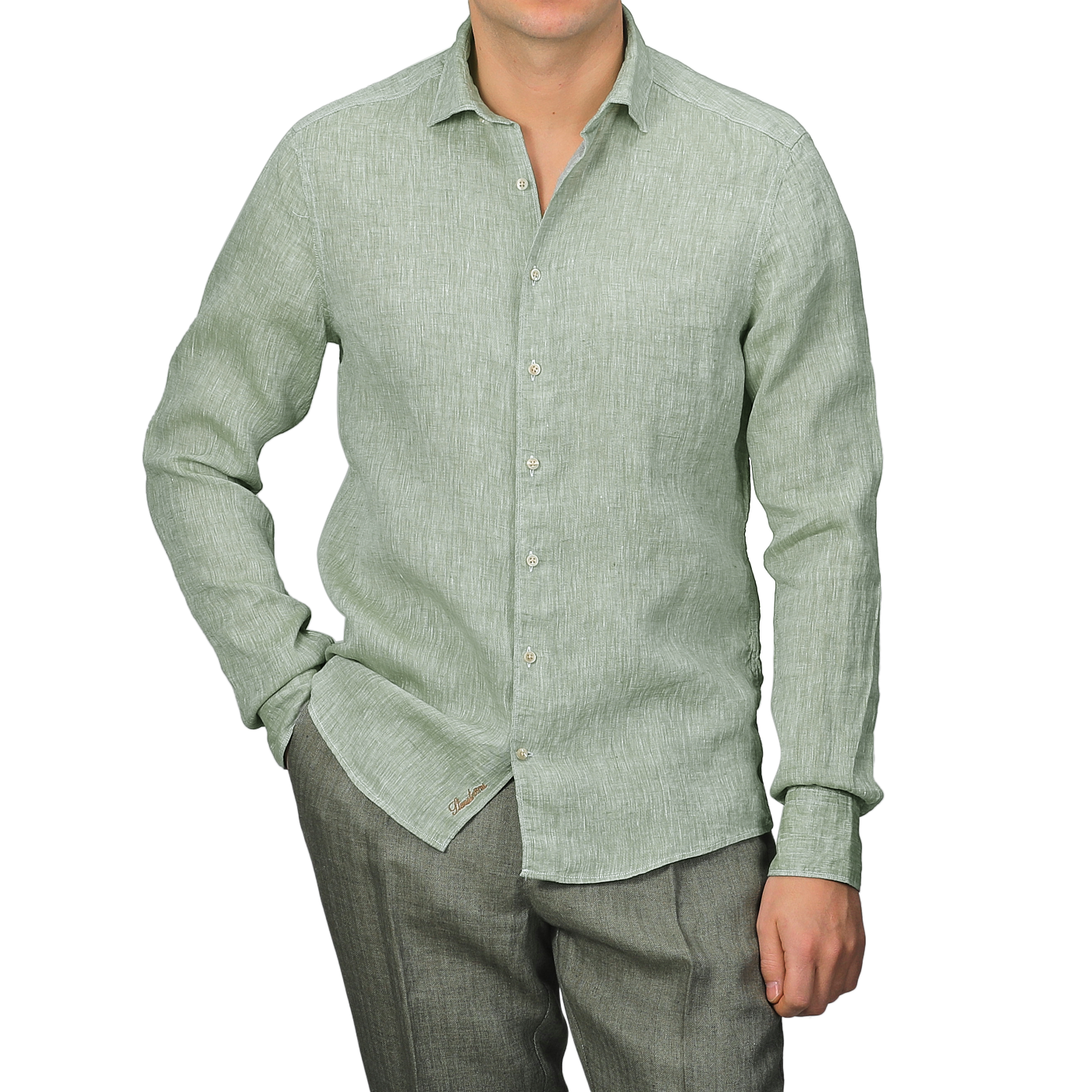 Someone in a Stenströms Light Green Linen Cutaway Fitted Body Shirt and gray pants stands against a neutral background, with the shirt untucked.