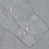 Close-up of a grey suit jacket sleeve with buttoned cuffs and Stenströms' Light Grey Linen Fitted Body Shirt.