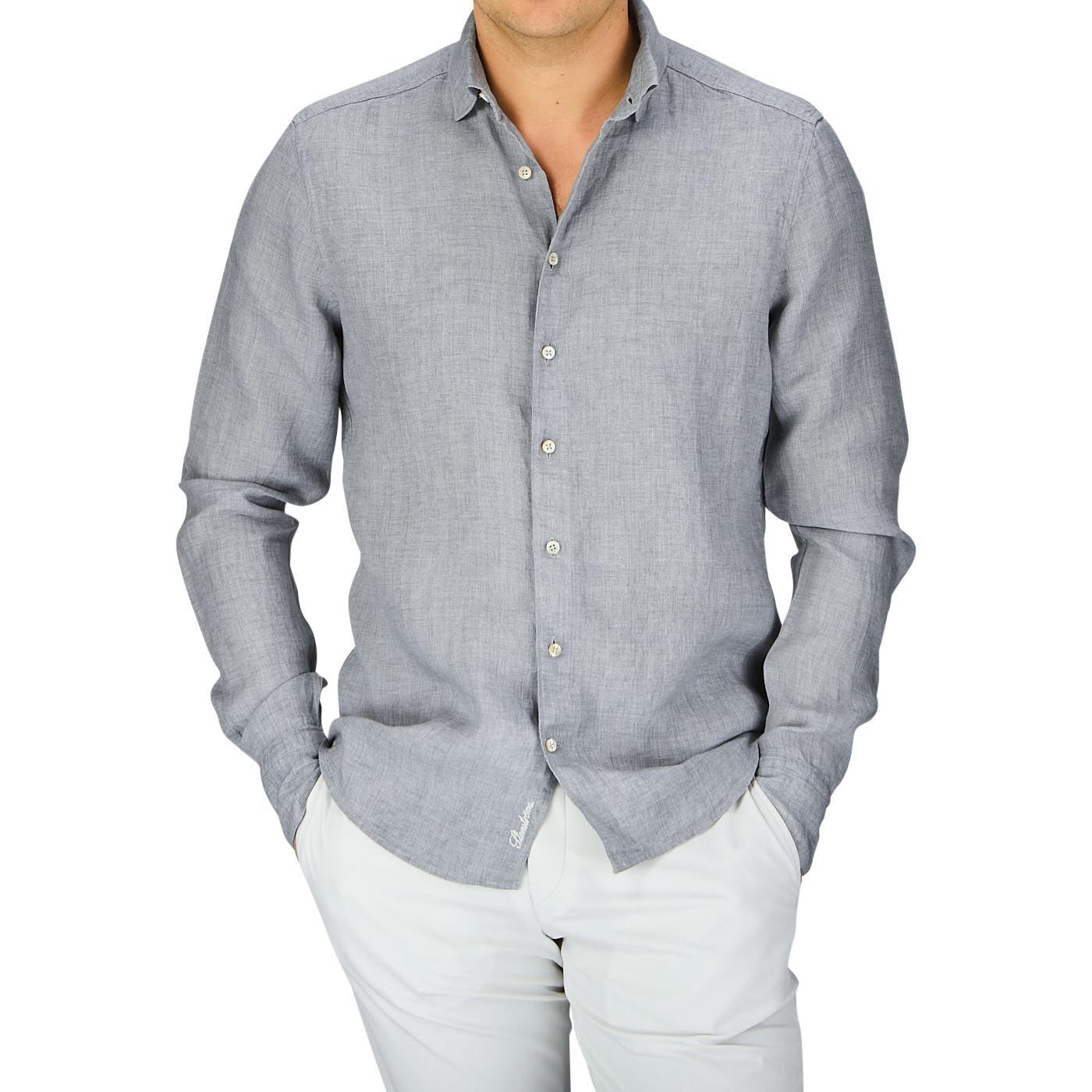 Man wearing a Stenströms Light Grey Linen Fitted Body Shirt with a cutaway collar and white pants.