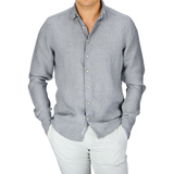 Man wearing a light gray linen Stenströms shirt with a slimline cut and white pants.