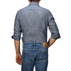 A person wearing a Mid Blue Linen Cutaway Slimline Shirt by Stenströms and accompanying jeans is shown from the back against a plain background.